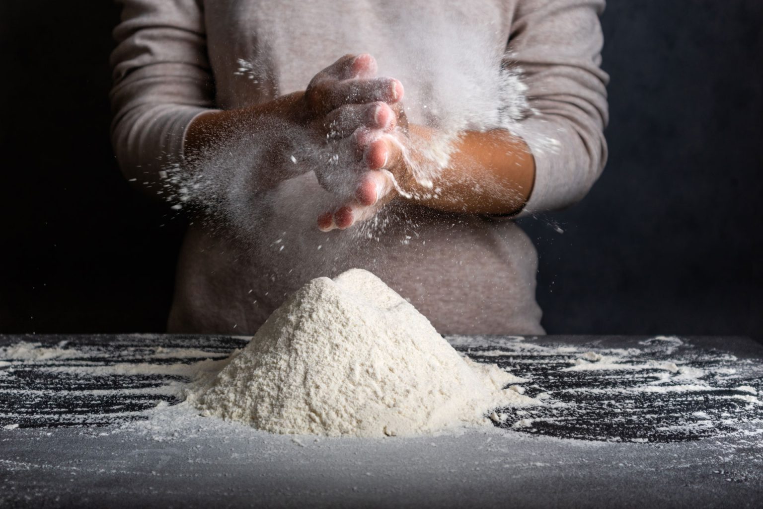 female hands kneading dough for cooking bread piz
